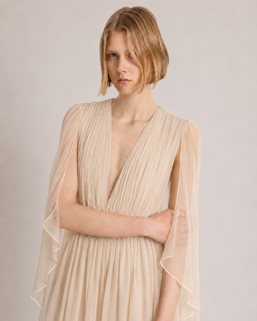 Long chiffon dress with V-neckline and cape