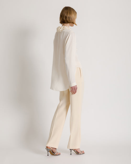 Fluid blouse with sculptural ruffled collar