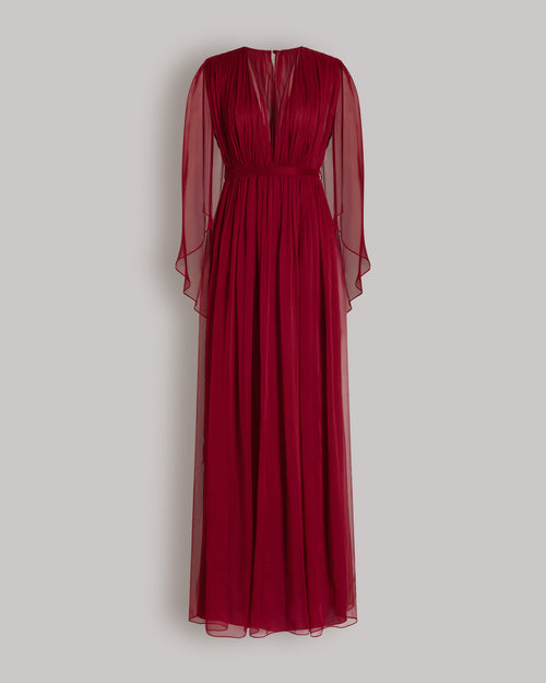 Long chiffon dress with V-neckline and cape