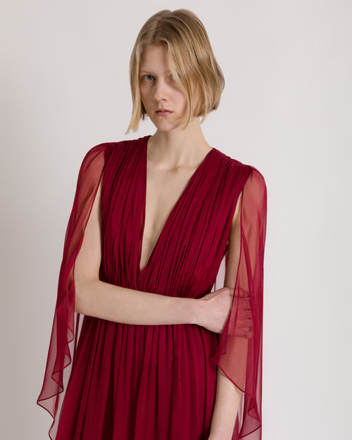 Long chiffon dress with V-neckline and cape