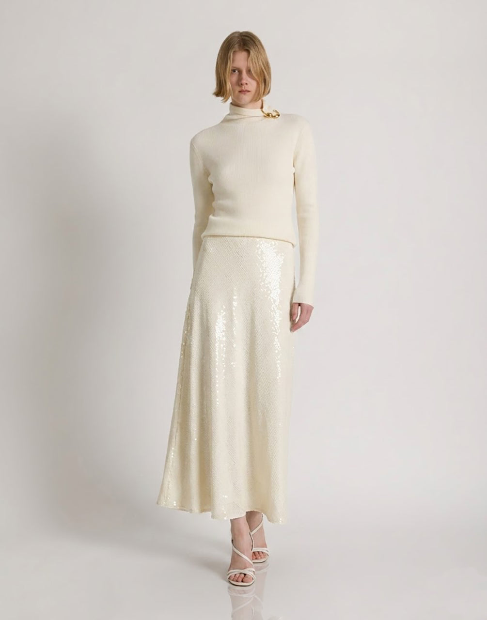 Wool, silk, and cashmere turtleneck sweater with floral brooch